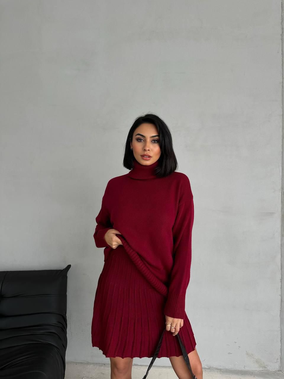 Women's suit with a short pleated skirt and an oversized sweater