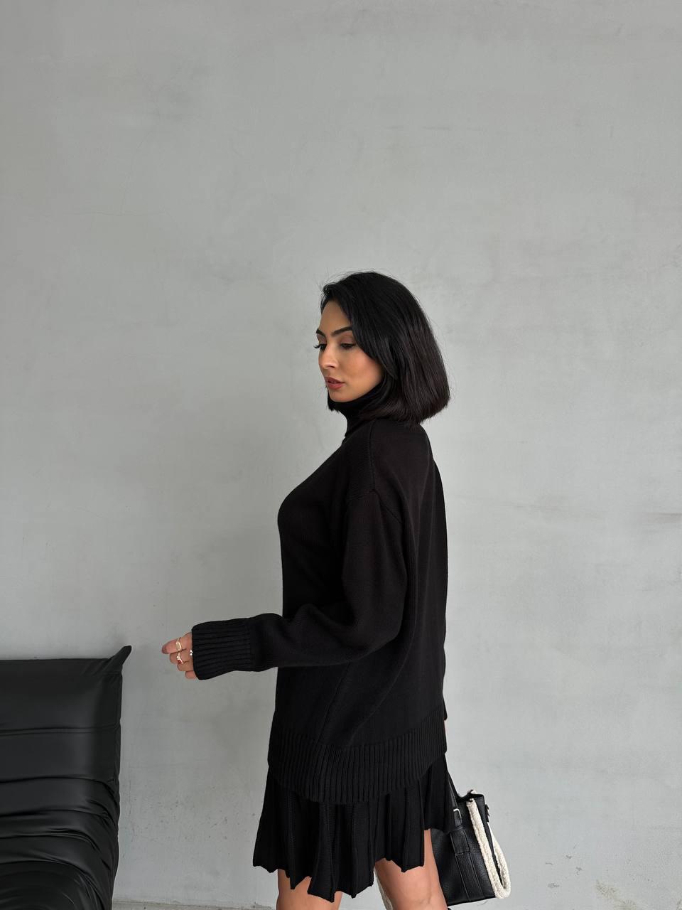 Women's suit with a short pleated skirt and an oversized sweater